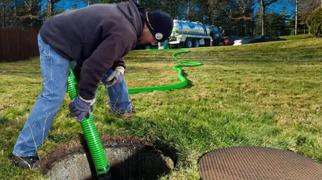 Service technician performing residential septic pumping and drainage maintenance in Milwaukee, WI